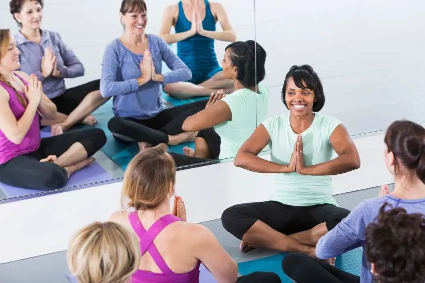 A person meditating by a serene Himalayan lake, practicing Kashmiri Shaivism techniques.
