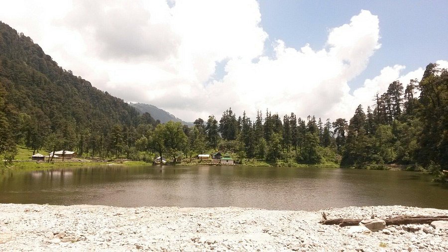 pristine alpine lake surrounded by dense forests