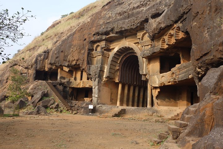 The ancient chaitya hall of Bhaja Caves, showing its distinctive horseshoe-shaped window and stone carvings.
