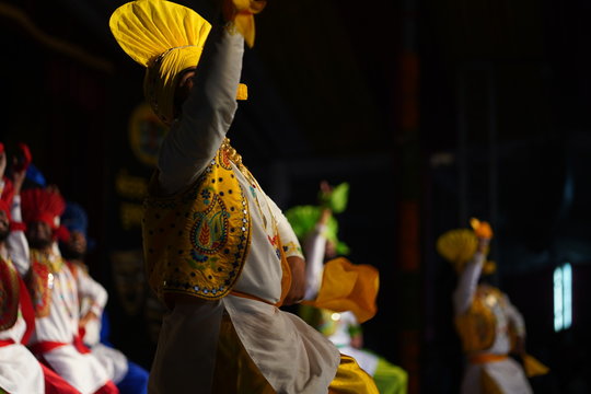 Energetic Bhangra dancers showcasing Punjabi folk culture with high-energy moves.