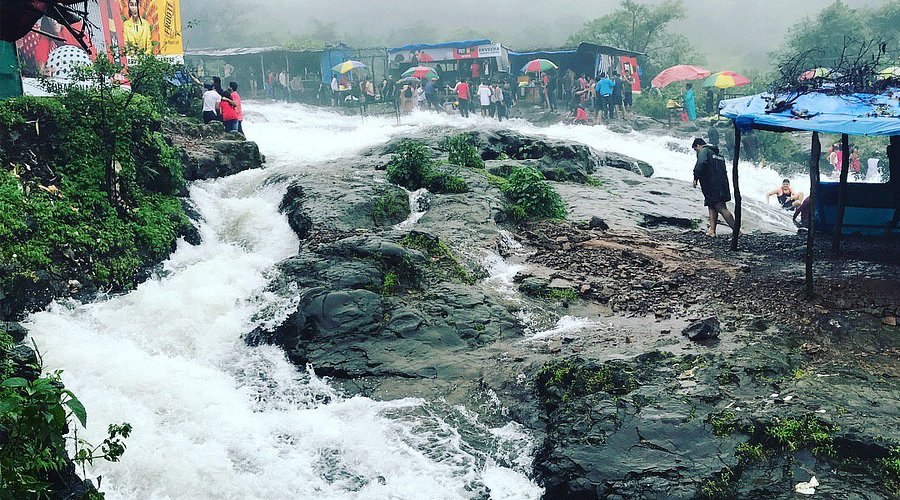 Famous Bhushi Dam waterfall places to visit Lonavala where visitors enjoy cascading water during monsoon