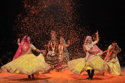 Performers in vibrant costumes enacting a traditional Braj folk dance.