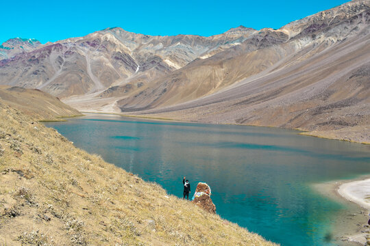The crescent-shaped Chandrataal Lake reflecting the sky, a pristine place to visit in Lahaul and Spiti.