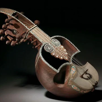 A sitar player performing Hindustani classical music on stage.