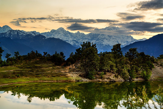 The mirror-like Deoria Tal reflecting Chaukhamba peaks, a serene lake near Chopta.