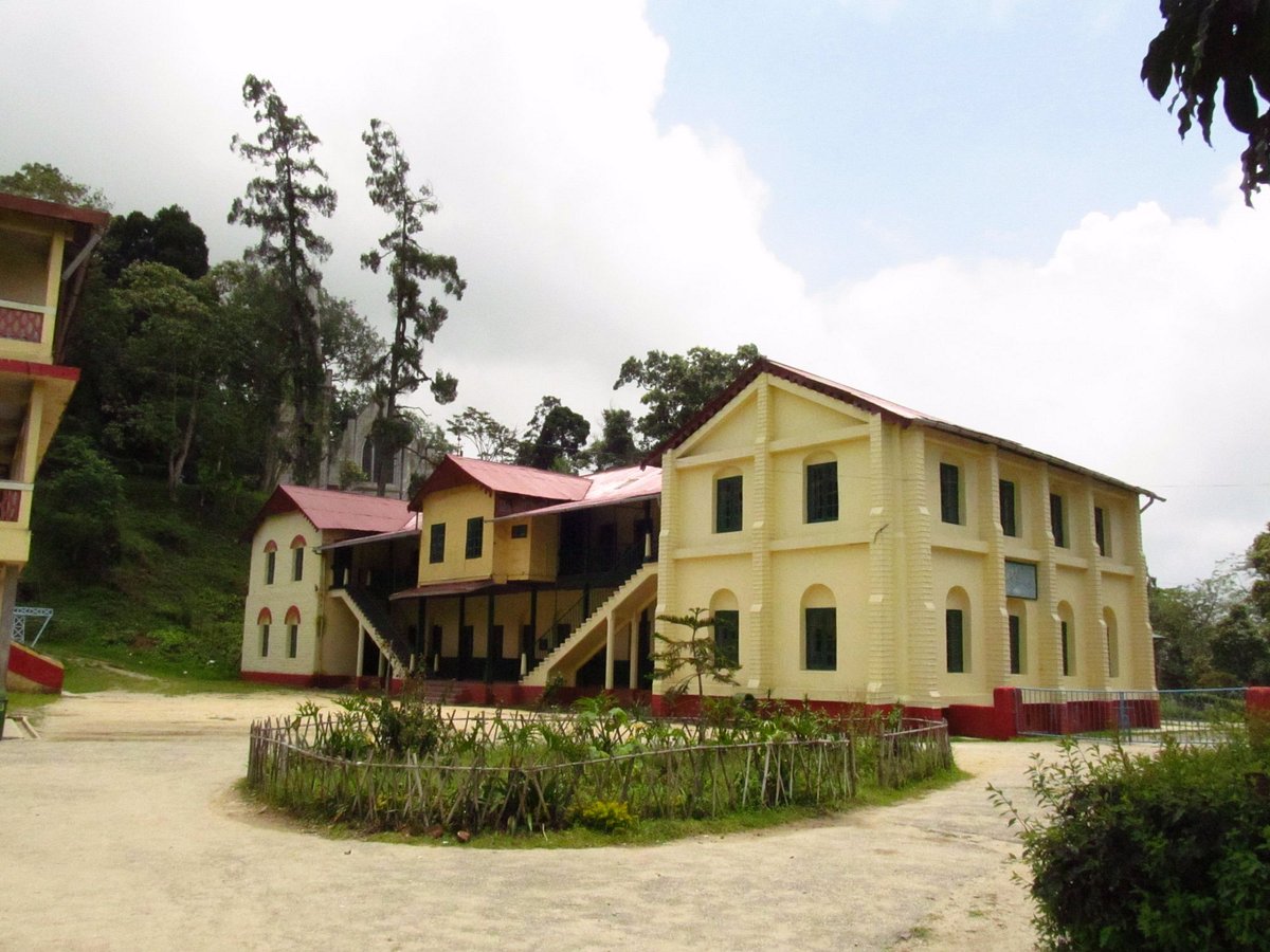 Sprawling campus with red-roofed cottages and historic church buildings, educational places to visit Kalimpong founded in 1900
