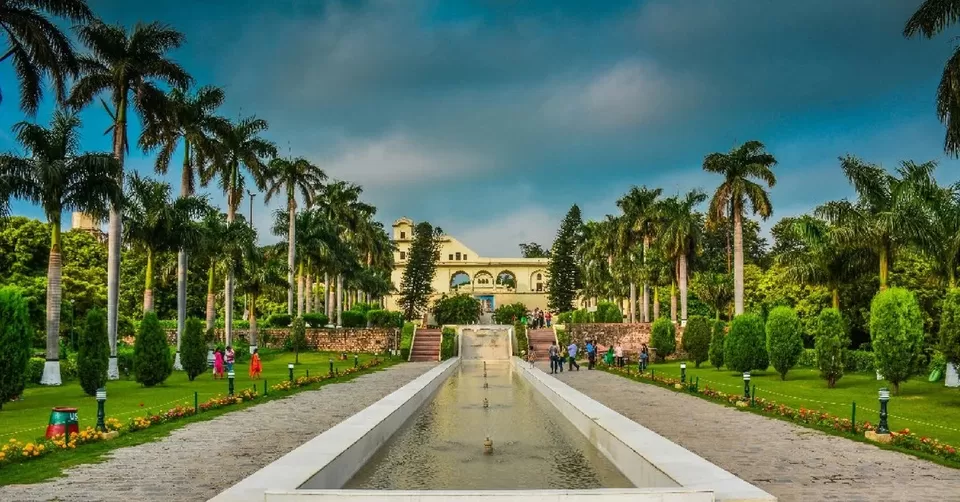 Visitors strolling through the lush, terraced lawns of historic Pinjore Gardens near Ambala.