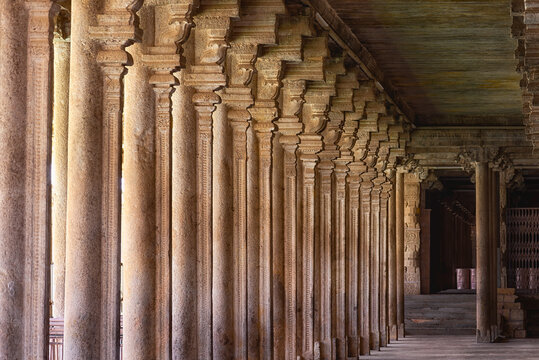 Devotees walking through the grand thousand-pillared corridors of Srirangam Temple in Tiruchirappalli.