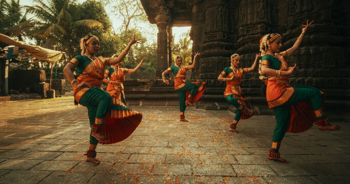 Performers in vibrant costumes dancing at a local cultural event.