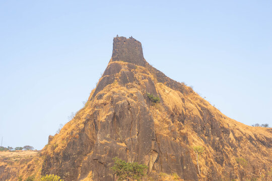 Trekking enthusiasts exploring historic forts amidst Sahyadri ranges in Satara