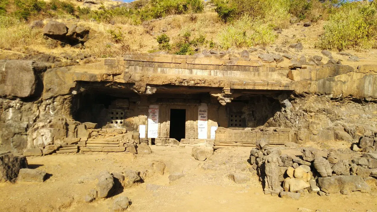 A group of trekkers climbing the ancient stone steps of a fort, surrounded by the misty green landscapes of Lonavala.