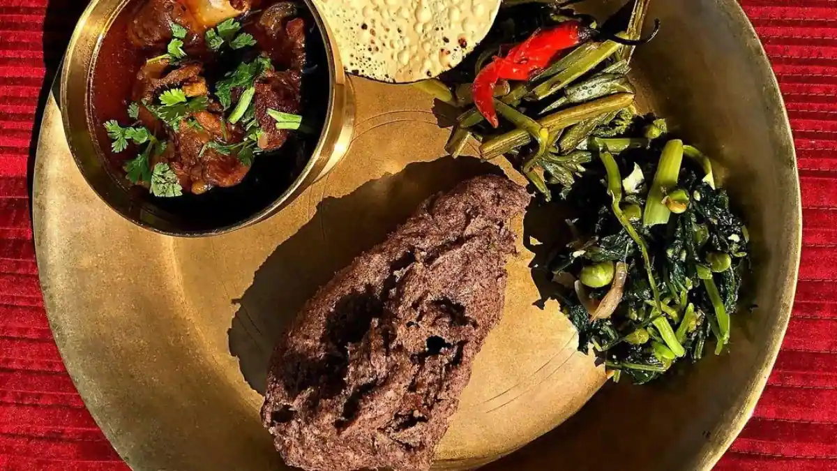 Traditional Nepali meal Gundruk and Dhindo fermented greens with millet flour preparation