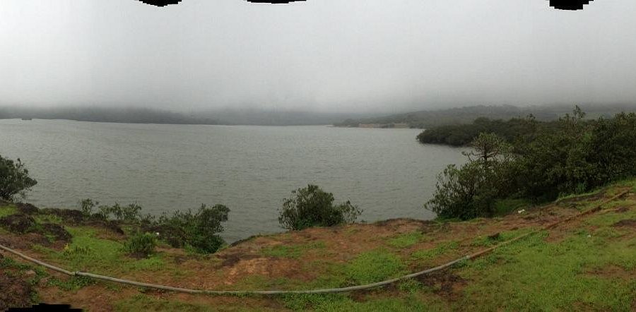 Calm waters of Kaas Lake reflecting the surrounding hills and blue skies.