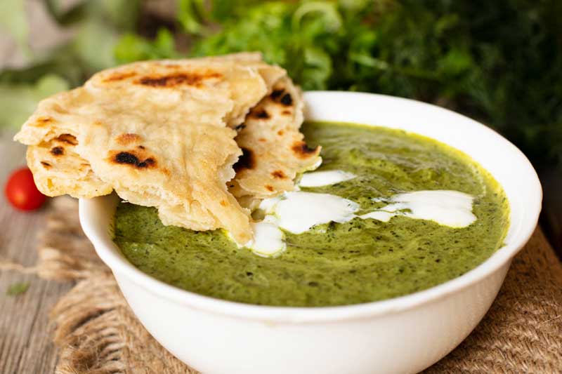 A nutritious green gravy made from spinach and fenugreek leaves, a local specialty.