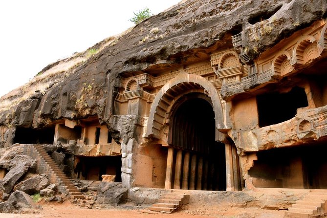 The grand entrance of the Karla Caves, an ancient Buddhist rock-cut structure with intricately carved pillars, located near Lonavala.