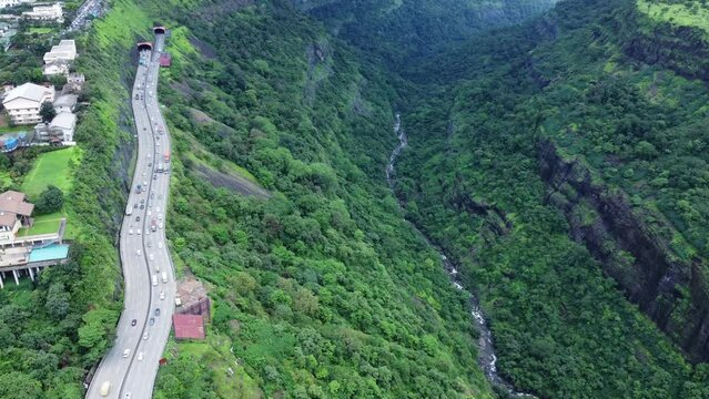 Dramatic aerial shot of the Khandala Ghat mountain pass, showcasing its famous curves and the beautiful valley below.
