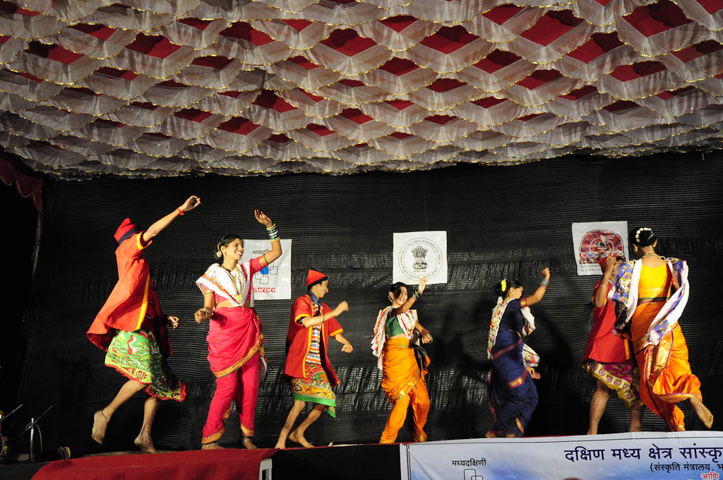 Koli dancers in traditional attire performing the fisherman's dance, with synchronized steps and colorful costumes.