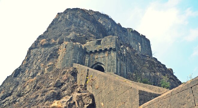 The imposing fortification walls of Lohagad Fort stretching along a ridge, a popular trekking destination with views of Lonavala.