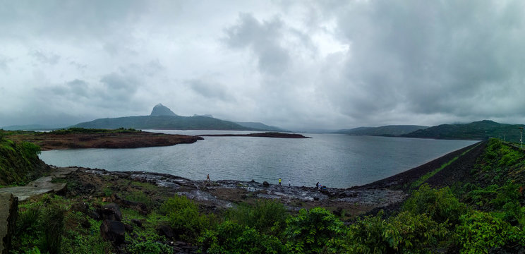 A tranquil evening scene at Lonavala Lake, a popular picnic spot near Khandala surrounded by hills and greenery.