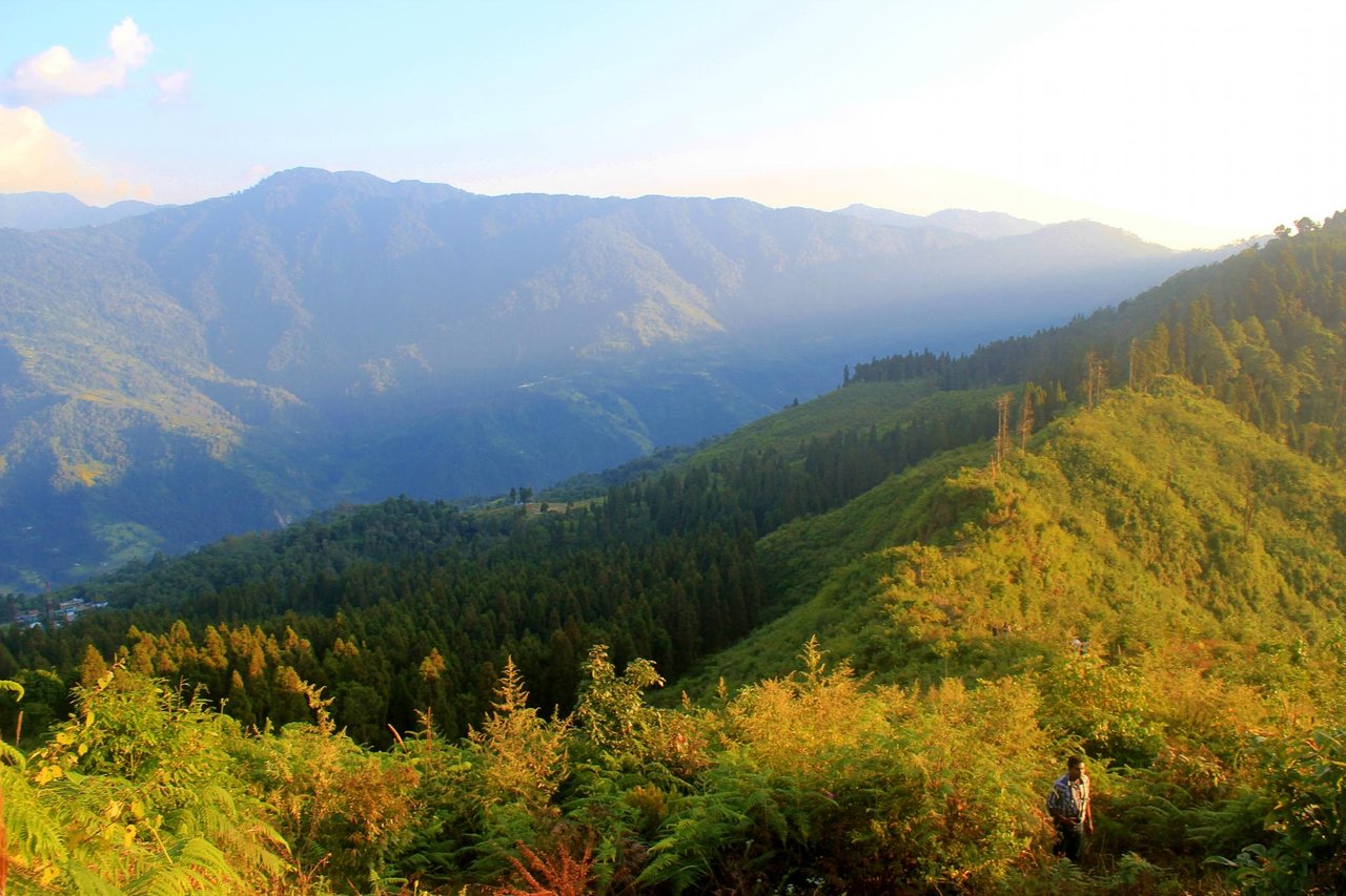 Ancient town with Buddhist monastery perched on hillside overlooking terraced farmlands
