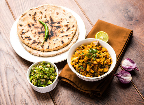 Traditional Maharashtrian meal of spicy gram flour curry with soft millet bread