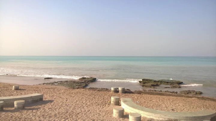 Scenic Porbandar Beach with golden sands and gentle waves perfect for peaceful sunset walks