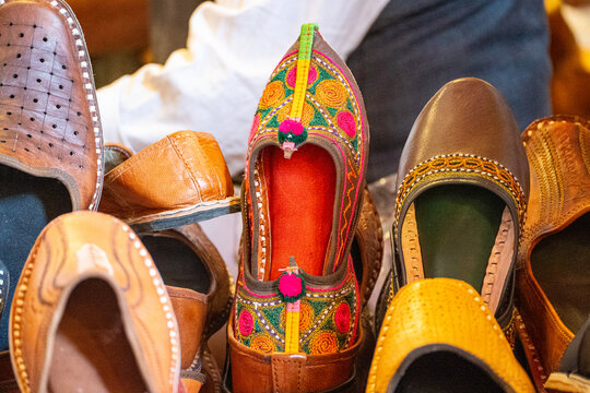 Colorful traditional Punjabi Jutti footwear with intricate embroidery and curved pointed toes