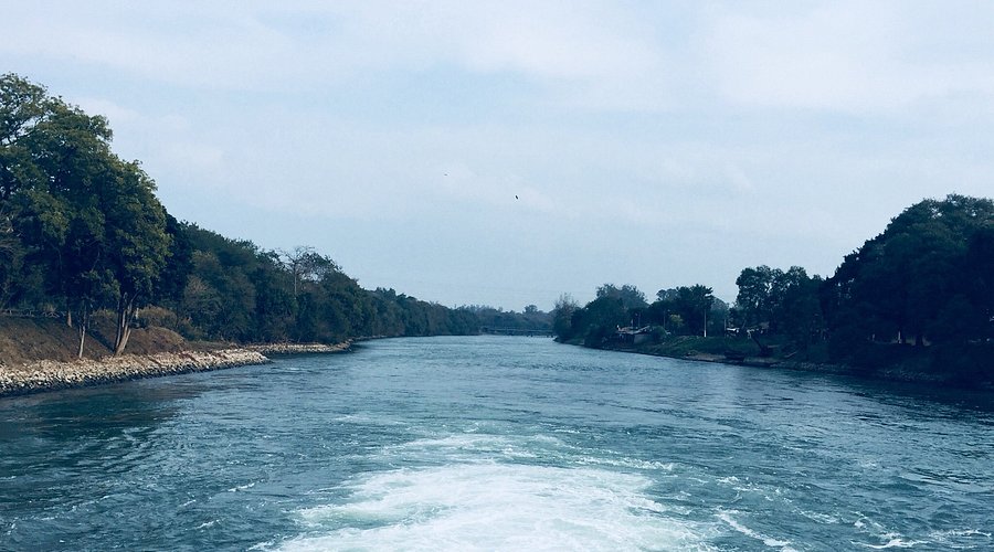 Serene Roopnagar Lake near Bathinda reflecting blue skies surrounded by lush greenery