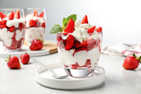 Fresh juicy strawberries served with cream, a specialty of the Satara region