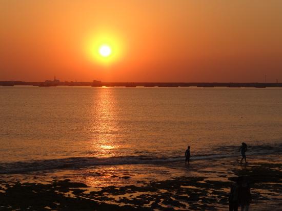 Romantic sunset stroll along Porbandar Beach with golden skies and gentle sea breeze