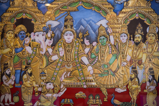 Intricate Tanjore painting featuring gold foil and semi-precious stones.