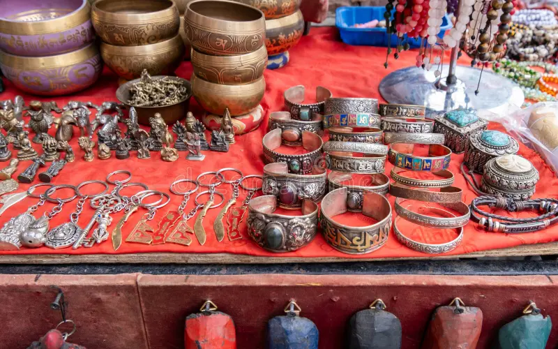 Colorful Tibetan handicrafts including prayer wheels, singing bowls, and traditional artifacts