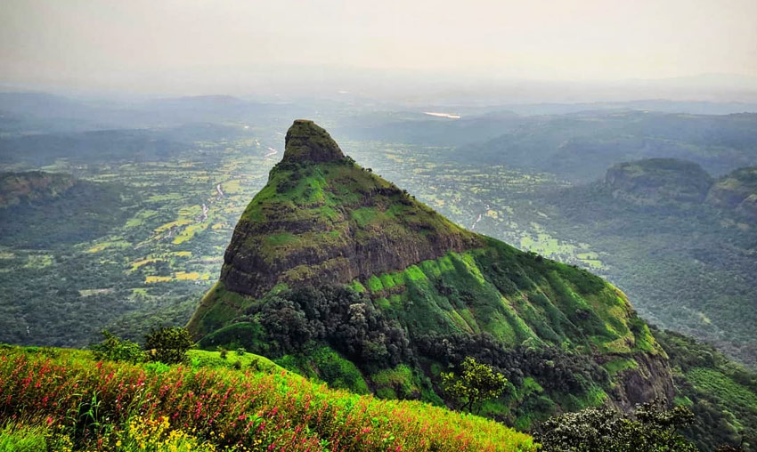 Dramatic Tiger's Leap cliff edge with plunging valleys and dense forests, an adventurous places to visit Khandala for thrill seekers.