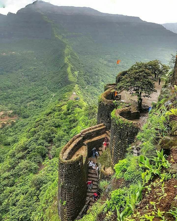 Triangular Tikona Fort dominating skyline with distinctive shape and walls, a unique places to visit Khandala for architecture buffs.
