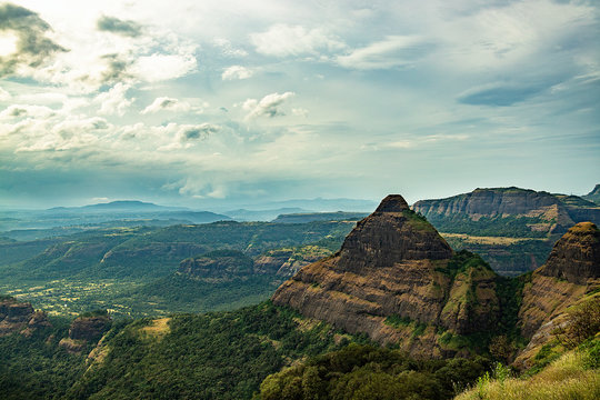 Breathtaking aerial view of a dramatic cliff edge in the Sahyadri mountains, offering a perfect vantage point over the Lonavala region.