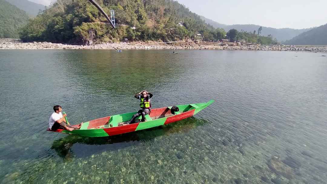 Coracle boats and bamboo rafting on the calm Umngot River at Shnongpdeng, a popular Places to Visit in Dawki for water activities