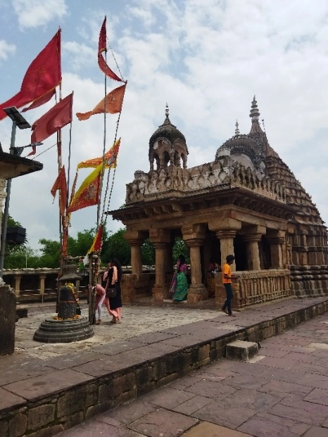 Gauri Shankar Temple inside the courtyard of Chausath Yogini Temple Bhedaghat with saffron flags and ornate Nagara style shikhara