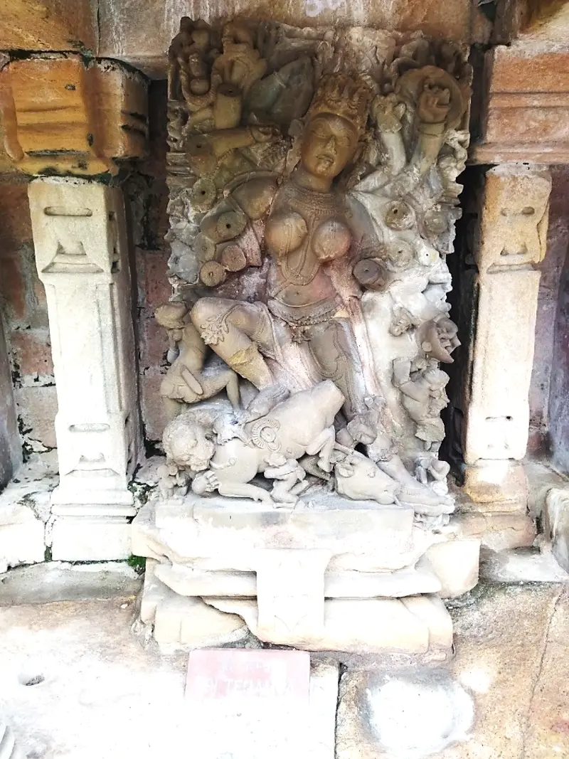 Stone sculpture of Mahisasuramardini Yogini slaying the buffalo demon, installed in a niche at Chausath Yogini Temple, Bhedaghat